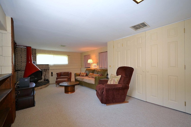 1318 Brooklyn Blvd, Bay Shore, NY 11706 - living area featuring a wood stove and carpet floors