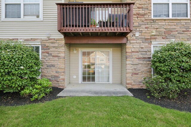 1080 Maggie Rd Unit 12-9, Newburgh, NY 12550 - rear view of property with a balcony, a lawn, and stone siding
