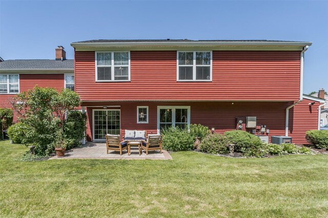 15 Candlestick Ct, Warwick, NY 10990 - rear view of house with an outdoor hangout area, a patio, a lawn, and a chimney