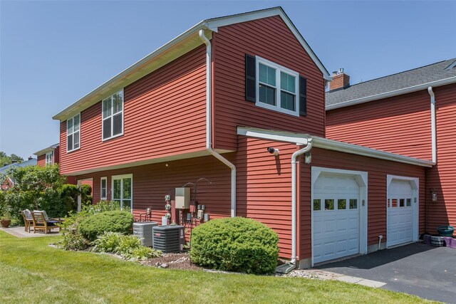 15 Candlestick Ct, Warwick, NY 10990 - rear view of property with a garage, driveway, a yard, central AC unit, and a chimney