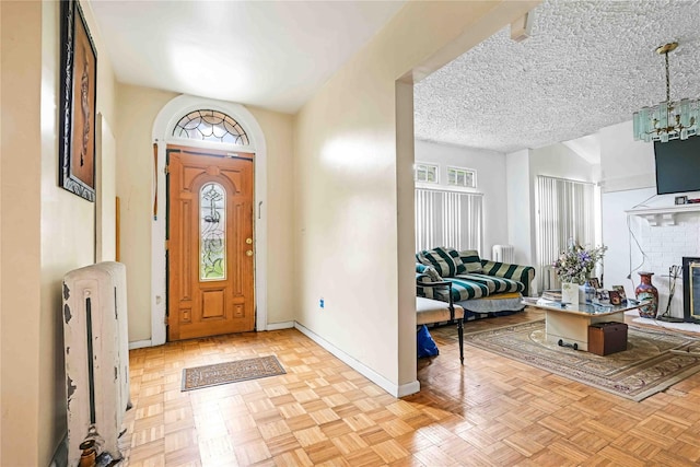 11480 178th Pl, Addisleigh Park, NY 11434 - foyer entrance with baseboards, a chandelier, and a brick fireplace