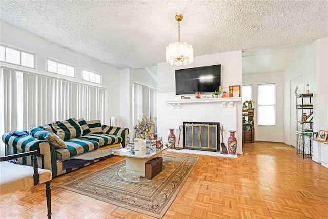 11480 178th Pl, Addisleigh Park, NY 11434 - living room featuring a textured ceiling, healthy amount of natural light, a chandelier, and a brick fireplace