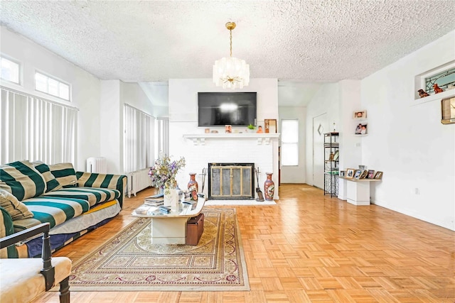 11480 178th Pl, Addisleigh Park, NY 11434 - living area with a textured ceiling, radiator, healthy amount of natural light, a fireplace, and a chandelier