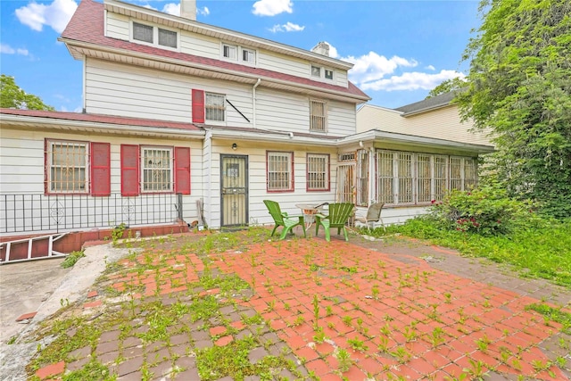 11480 178th Pl, Addisleigh Park, NY 11434 - back of house with a patio, a sunroom, and a chimney