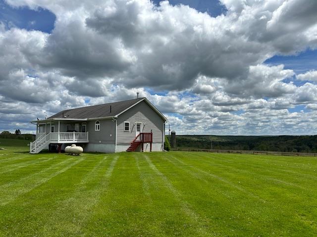 6452 State Route 52, Lake Huntington, NY 12752 - rear view of property featuring a lawn