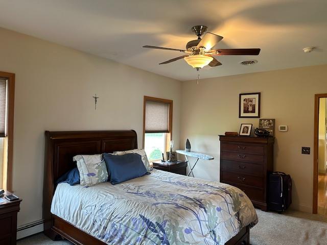 6452 State Route 52, Lake Huntington, NY 12752 - bedroom featuring a baseboard heating unit, light colored carpet, and ceiling fan