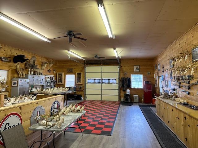 6452 State Route 52, Lake Huntington, NY 12752 - garage featuring wooden walls, a ceiling fan, and freestanding refrigerator