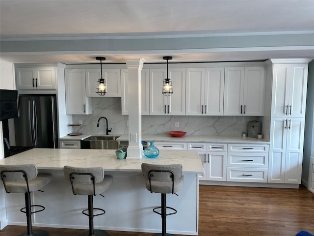855 E Broadway Unit 3D, Long Beach, NY 11561 - kitchen featuring a sink, freestanding refrigerator, white cabinetry, and backsplash