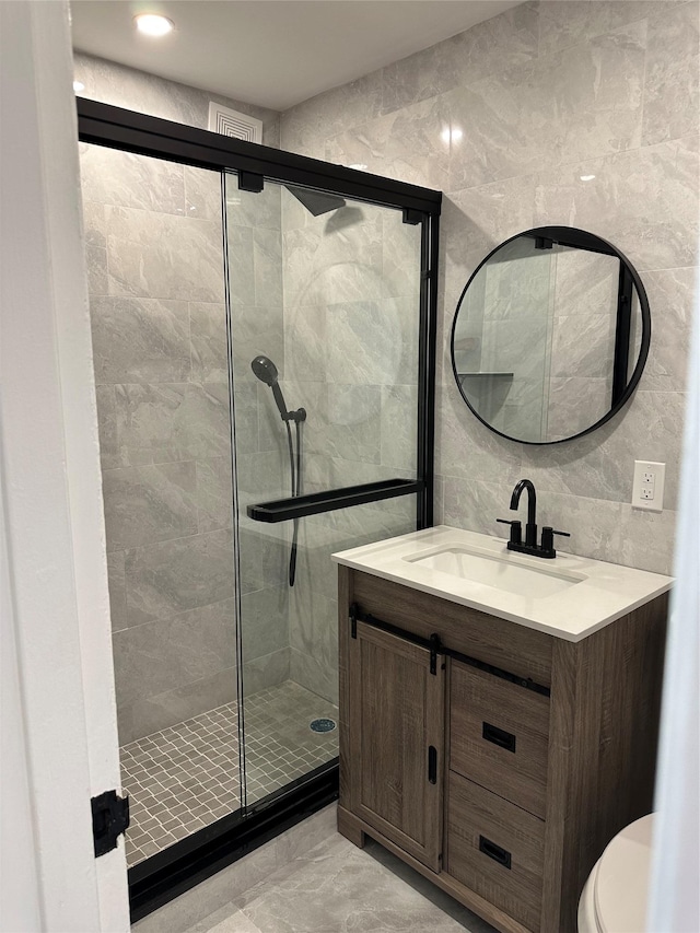 855 E Broadway Unit 3D, Long Beach, NY 11561 - full bathroom with tile walls, marble finish flooring, a shower stall, vanity, and toilet