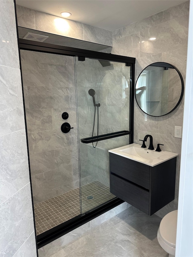 855 E Broadway Unit 3D, Long Beach, NY 11561 - full bath with tile walls, a stall shower, vanity, and toilet