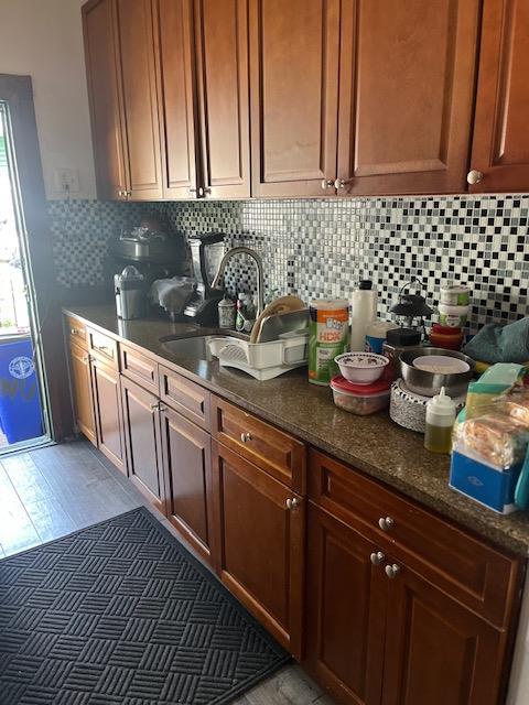 5436 Nurge Ave, Maspeth, NY 11378 - kitchen with a sink, tasteful backsplash, and dark stone countertops