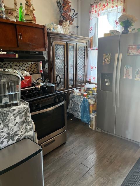 5436 Nurge Ave, Maspeth, NY 11378 - kitchen with appliances with stainless steel finishes, wood-type flooring, under cabinet range hood, and backsplash