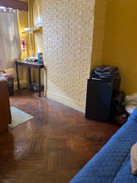 5436 Nurge Ave, Maspeth, NY 11378 - detailed view of fridge, a fire extinguisher, and wood finished floors