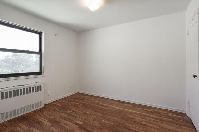 67-09 136th St Unit B, Kew Garden Hills, NY 11367 - empty room with radiator and wood finished floors