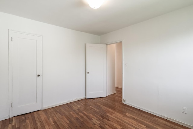67-09 136th St Unit B, Kew Garden Hills, NY 11367 - unfurnished bedroom with wood finished floors and baseboards