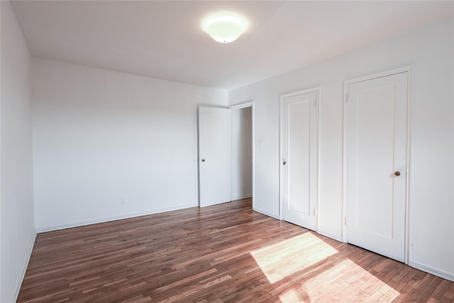 67-09 136th St Unit B, Kew Garden Hills, NY 11367 - unfurnished bedroom with wood finished floors and baseboards