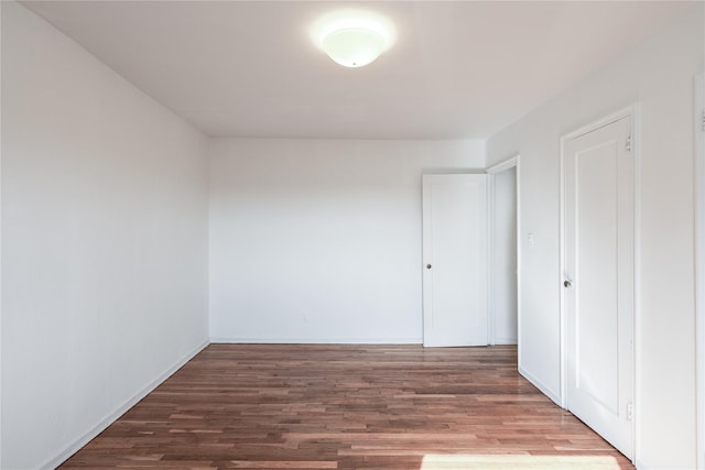 67-09 136th St Unit B, Kew Garden Hills, NY 11367 - unfurnished bedroom featuring wood finished floors and baseboards