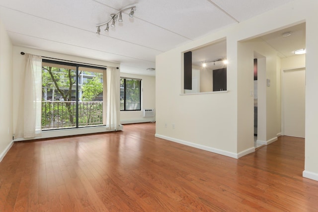 1155 Warburton Ave Unit 4G, Yonkers, NY 10701 - spare room with wood finished floors, healthy amount of natural light, and rail lighting