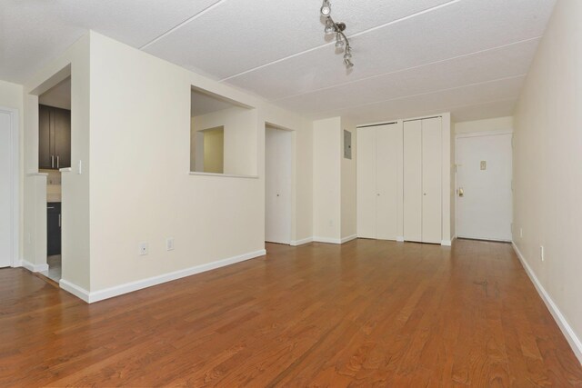 1155 Warburton Ave Unit 4G, Yonkers, NY 10701 - unfurnished living room featuring wood finished floors and rail lighting