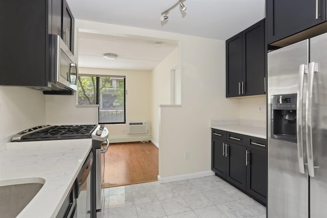 1155 Warburton Ave Unit 4G, Yonkers, NY 10701 - kitchen with appliances with stainless steel finishes, dark cabinets, light stone countertops, and rail lighting