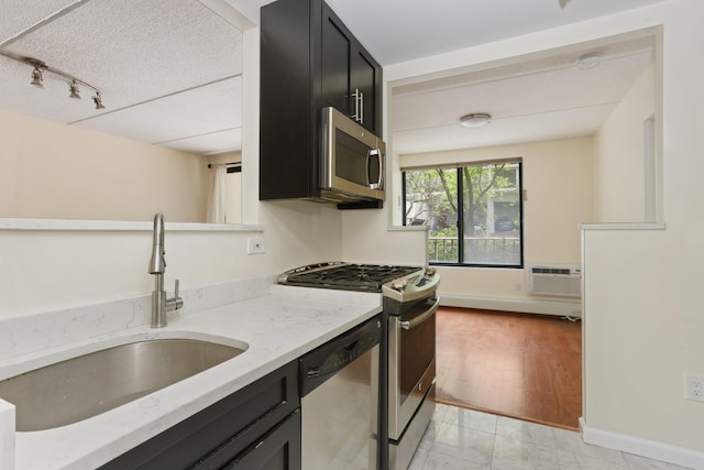 1155 Warburton Ave Unit 4G, Yonkers, NY 10701 - kitchen with stainless steel appliances, dark cabinets, light stone countertops, and rail lighting