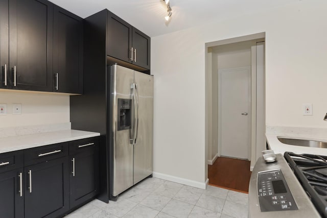 1155 Warburton Ave Unit 4G, Yonkers, NY 10701 - kitchen featuring appliances with stainless steel finishes, light marble finish flooring, light countertops, and dark cabinetry