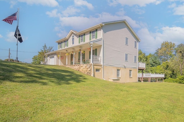 2 Joseph St, West Haverstraw, NY 10993 - back of house with covered porch, a lawn, and a garage
