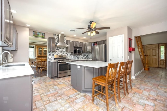 2 Joseph St, West Haverstraw, NY 10993 - kitchen with appliances with stainless steel finishes, a sink, wall chimney range hood, gray cabinetry, and tasteful backsplash