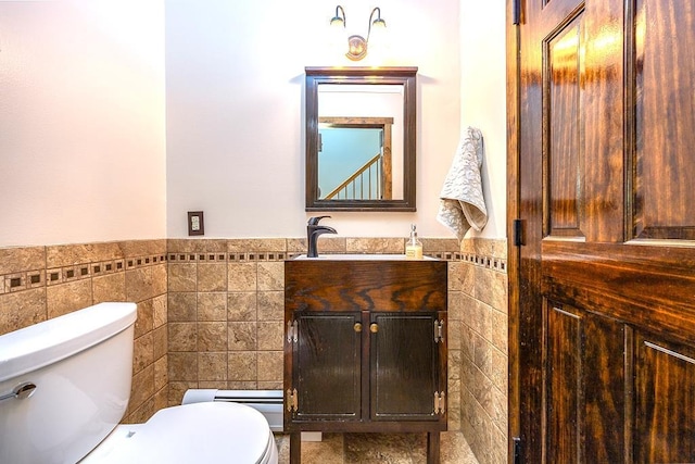 2 Joseph St, West Haverstraw, NY 10993 - half bath with tile walls, toilet, vanity, a wainscoted wall, and baseboard heating