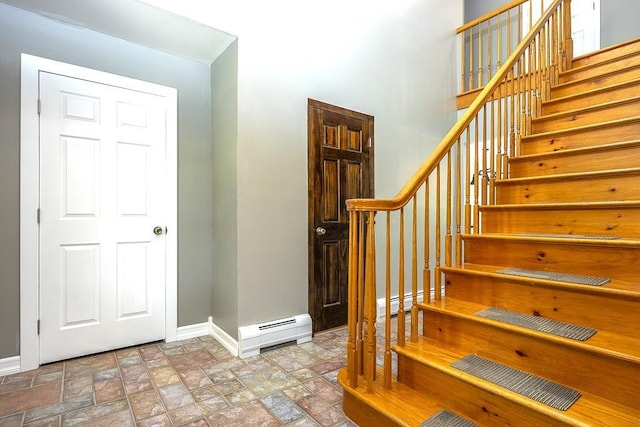 2 Joseph St, West Haverstraw, NY 10993 - stairway with a baseboard radiator, baseboards, and stone finish floors