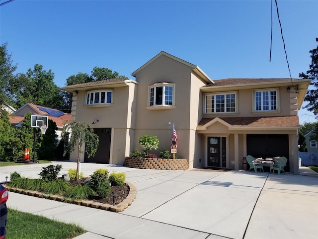 526 Hazel Dr, Woodmere, NY 11598 - view of front of property featuring an attached garage, stucco siding, and driveway