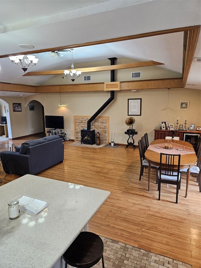 526 Hazel Dr, Woodmere, NY 11598 - dining area featuring arched walkways, a wood stove, and light wood-type flooring