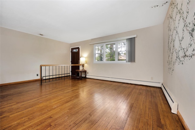 53 Wiltshire Dr, Commack, NY 11725 - spare room with a baseboard radiator, wood-type flooring, and a baseboard heating unit