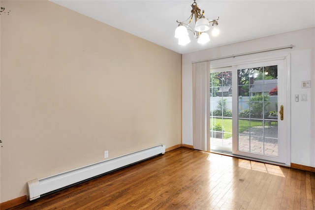 53 Wiltshire Dr, Commack, NY 11725 - spare room featuring a baseboard radiator, a chandelier, and hardwood / wood-style floors