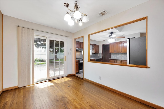 53 Wiltshire Dr, Commack, NY 11725 - unfurnished dining area with wood finished floors, a chandelier, and ceiling fan