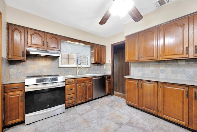 53 Wiltshire Dr, Commack, NY 11725 - kitchen featuring stainless steel appliances, under cabinet range hood, ceiling fan, brown cabinets, and light countertops