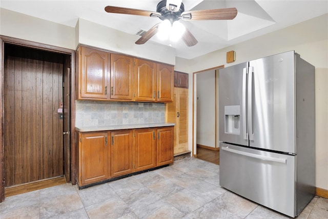 53 Wiltshire Dr, Commack, NY 11725 - kitchen featuring stainless steel refrigerator with ice dispenser, brown cabinetry, light countertops, backsplash, and a ceiling fan