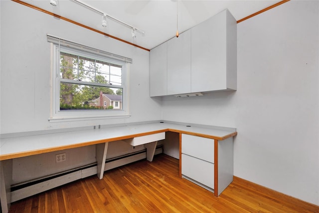 53 Wiltshire Dr, Commack, NY 11725 - unfurnished office with built in study area, rail lighting, light wood-type flooring, and a baseboard radiator