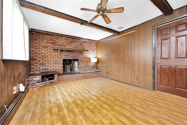53 Wiltshire Dr, Commack, NY 11725 - unfurnished living room featuring beam ceiling, a fireplace, baseboard heating, ceiling fan, and wood finished floors