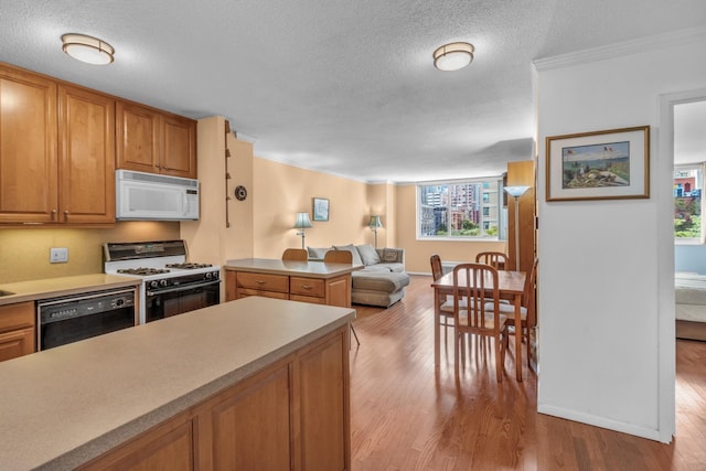 345 E 93rd St Unit 4D, New York Manhattan, NY 10128 - kitchen featuring white appliances, light wood-type flooring, open floor plan, crown molding, and light countertops