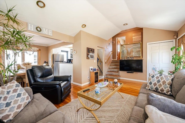 22 Cheshire Rd, Inwood, NY 11096 - living area with baseboards, light wood-type flooring, stairs, and lofted ceiling
