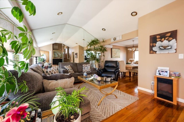 22 Cheshire Rd, Inwood, NY 11096 - living area featuring wood finished floors, vaulted ceiling, a chandelier, and baseboards