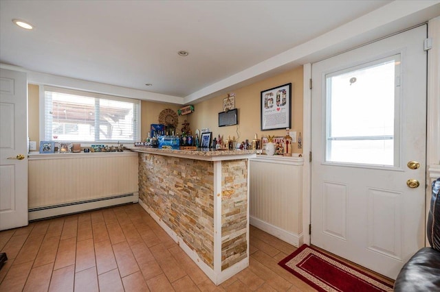 22 Cheshire Rd, Inwood, NY 11096 - indoor dry bar featuring a baseboard radiator, light wood-style flooring, a wainscoted wall, and recessed lighting