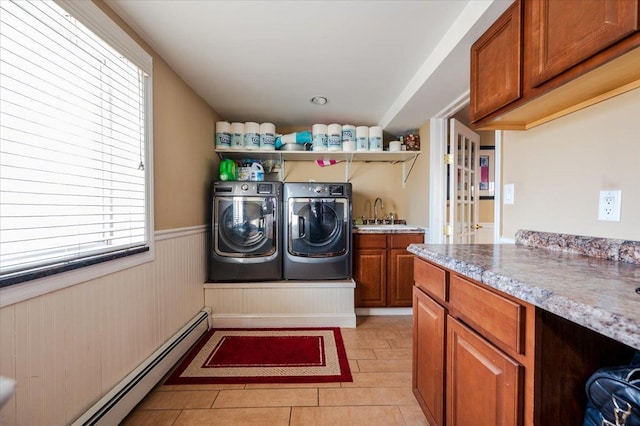 22 Cheshire Rd, Inwood, NY 11096 - laundry area featuring washing machine and clothes dryer, a baseboard heating unit, cabinet space, a wainscoted wall, and light tile patterned floors