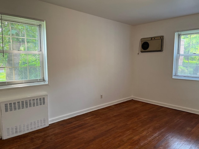 210-12 69th Ave Lower, Lower, Oakland Gardens, NY 11364 - spare room with radiator heating unit, dark wood finished floors, and baseboards