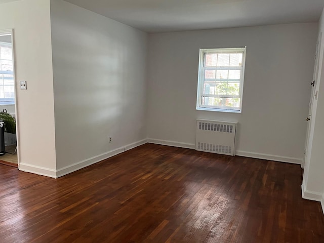 210-12 69th Ave Lower, Lower, Oakland Gardens, NY 11364 - unfurnished room featuring radiator, dark wood-type flooring, and baseboards