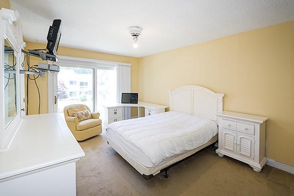 223 Springmeadow Dr Unit E, Holbrook, NY 11741 - bedroom featuring light carpet and baseboards
