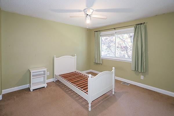 223 Springmeadow Dr Unit E, Holbrook, NY 11741 - carpeted bedroom featuring baseboards and a ceiling fan
