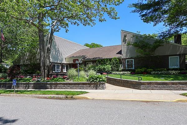 223 Springmeadow Dr Unit E, Holbrook, NY 11741 - view of front facade with a front lawn