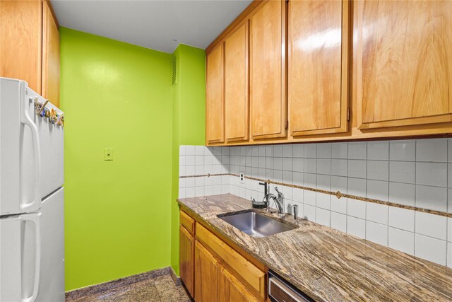 230 Garth Rd Unit 1A1, Scarsdale, NY 10583 - kitchen featuring freestanding refrigerator, a sink, decorative backsplash, baseboards, and dark stone countertops